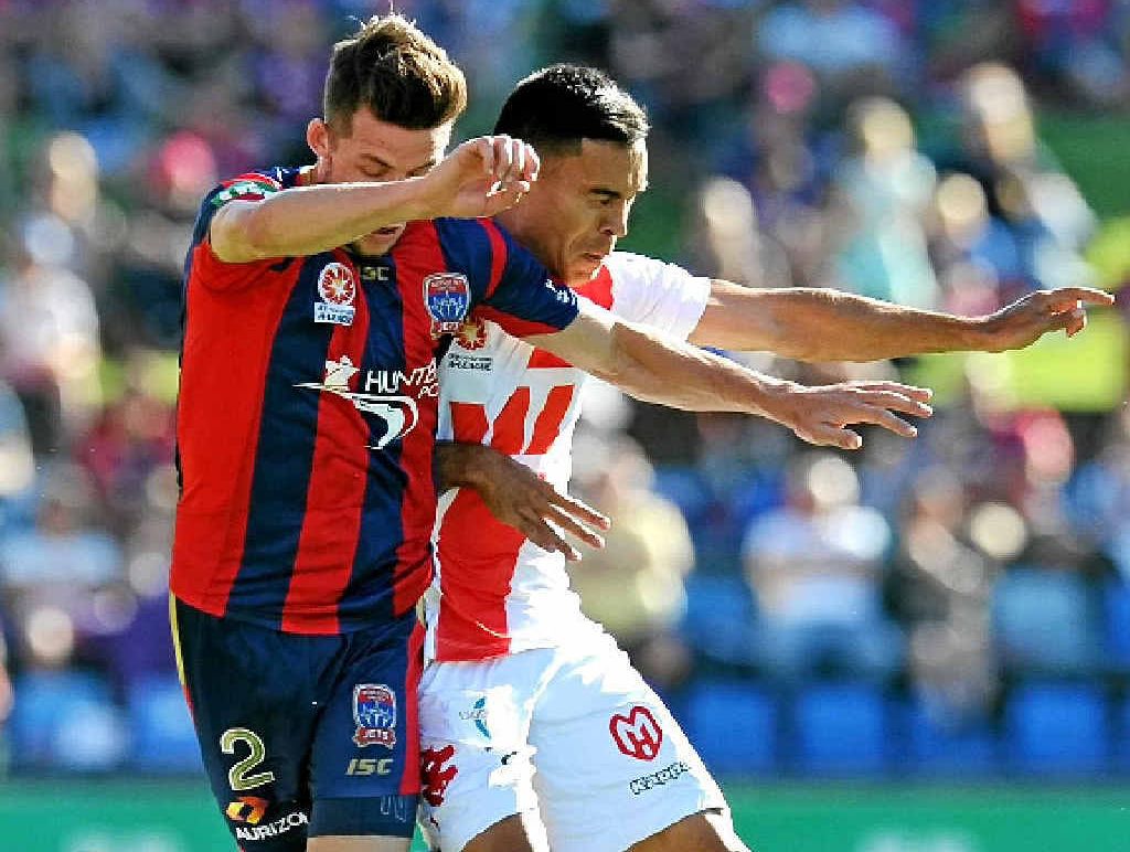 HEART ATTACK: Newcastle defender Scott Neville (left) is knocked off the ball by Melbourne Heart rival Ian Ramsay during their A-League match at Hunter Stadium. HEART ATTACK: Newcastle defender Scott Neville (left) is knocked off the ball by Melbourne Heart rival Ian Ramsay during their A-League match at Hunter Stadium.